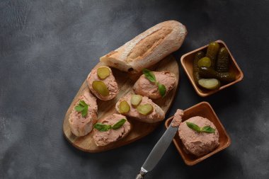Chicken or goose liver pate sandwiches on a wooden board
