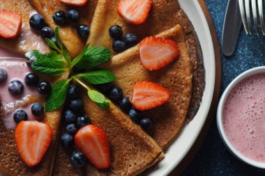 Taze yaban mersinli, naneli ve çilekli krep. Sağlıklı kahvaltı kavramı