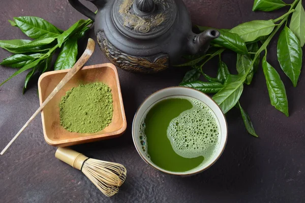 Green matcha tea drink and tea accessories on white background. Japanese tea ceremony concept. Detox tea. Antioxidant drink