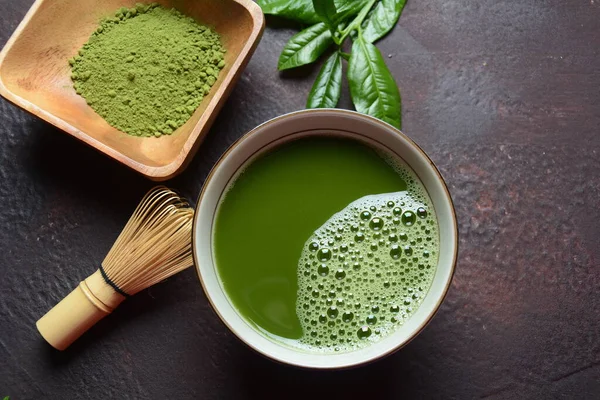 Green matcha tea drink and tea accessories on white background. Japanese tea ceremony concept. Detox tea. Antioxidant drink