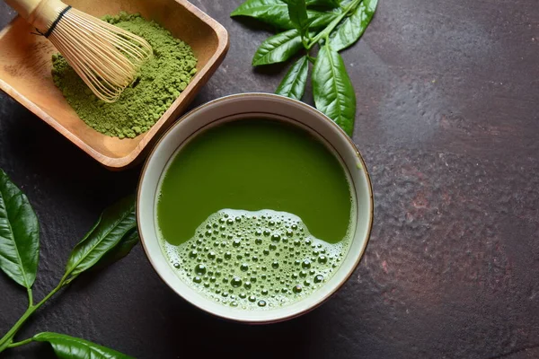 Green matcha tea drink and tea accessories on white background. Japanese tea ceremony concept. Detox tea. Antioxidant drink