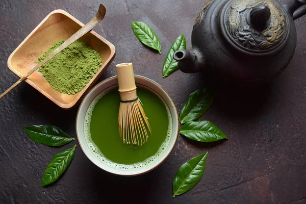 Green matcha tea drink and tea accessories on white background. Japanese tea ceremony concept. Detox tea. Antioxidant drink