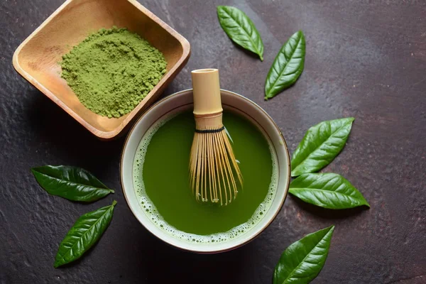 Green matcha tea drink and tea accessories on white background. Japanese tea ceremony concept. Detox tea. Antioxidant drink