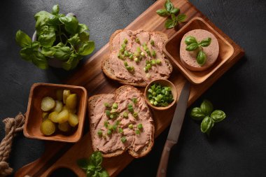 Chicken or goose liver pate sandwiches on a wooden board