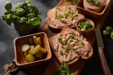 Chicken or goose liver pate sandwiches on a wooden board