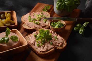 Chicken or goose liver pate sandwiches on a wooden board