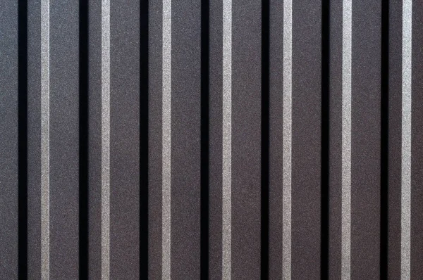 Abstract of monochrome metal blinds with a straight horizontal view, showing contrasting highlights and shadows.