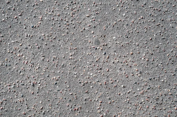 Текстура фона каменной черно-серой асфальтовой дороги с мелкой галькой . — стоковое фото