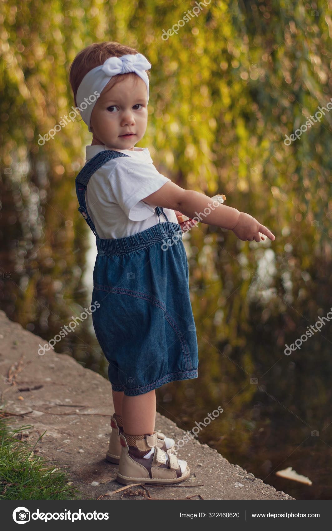 little girl in overalls