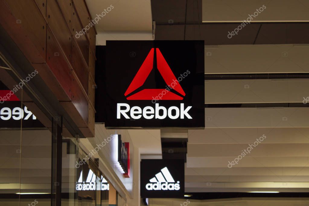 Minsk, Belarus - november 1, 2019 : Logo of Reebok, adidas logo on background in mall