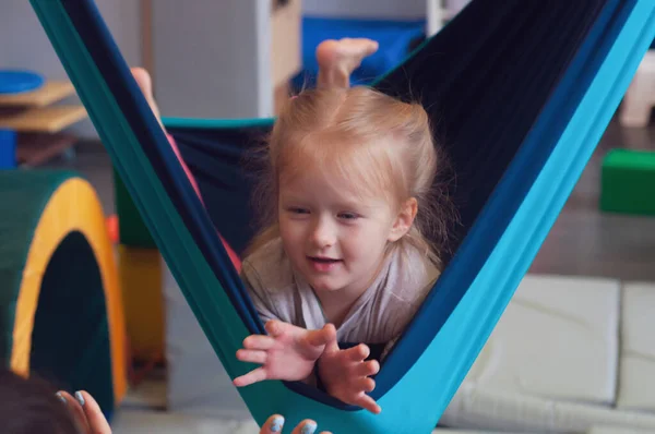 Cute Little Girl Enjoying Sensory Therapy Hammock While Her Physiotherapist — Stock Photo, Image