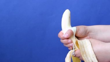 Female hands hold banana fruit imitates jerk. Close up of banana representing man penis while masturbating and orgasm