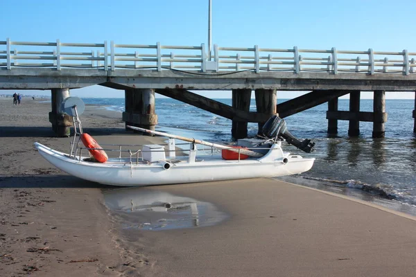 a life raft. a boat stranded or parked on the sandy beach in broad daylight