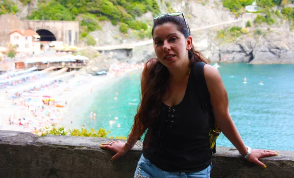 brunette caucasian curvy girl on a lookout point on the Cinque Terre coast in summer