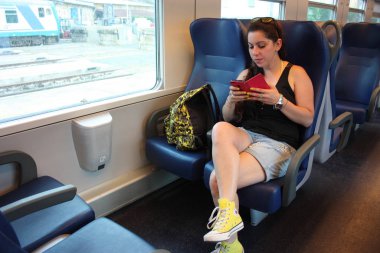 young woman traveling on a regional train