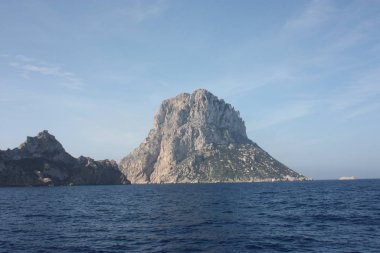Es Vedra adası İbiza denizinin mavi sularındaki sisin arasında.