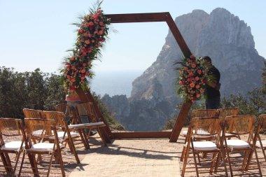 Getting married in Ibiza in summer. Dream wedding preparation in Cala D'Hort in front of the magical islet of Es Vedra to celebrate love clipart