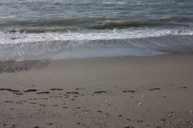 İtalya 'da Versilian Rivierası' nda soğuk ve donuk renkleri olan dalgalı denizleri olan bir kış plajı.