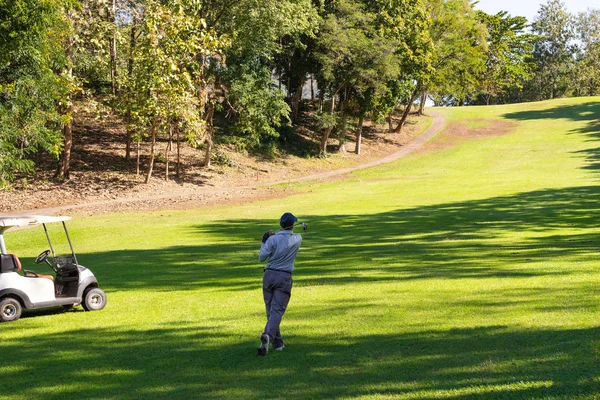 Man playing golf on a golf course.