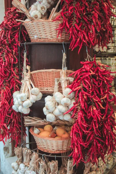 Local market in Palma de Mallorca, Spain. Fresh chili peppers, garlic and lemons in and next to baskets.