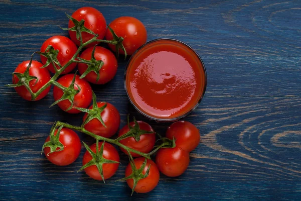 Fresh tomato juice on a blue background — Stock Photo, Image