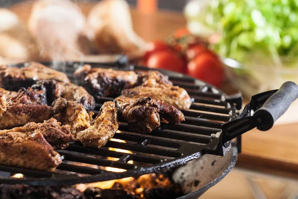 Grilling chicken wings on barbecue grill — Stock Photo, Image