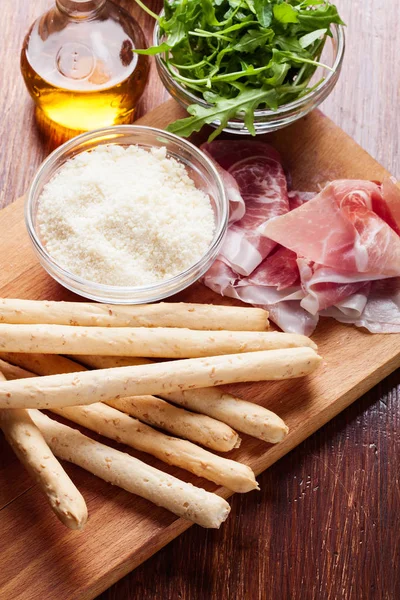 Italian grissini with ham prosciutto, mozzarella and arugula — Stock Photo, Image