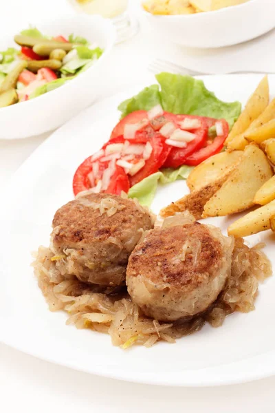 Almôndegas com cebola cozida e fatias de batata frita — Fotografia de Stock