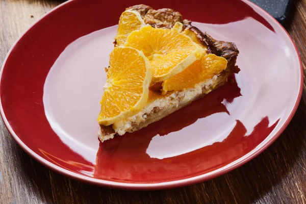 Slice of tart with cheese and sliced orange — Stock Photo, Image