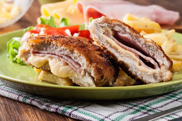 Cutlet Cordon Bleu with pork loin served with French fries and salad — Stock Photo, Image