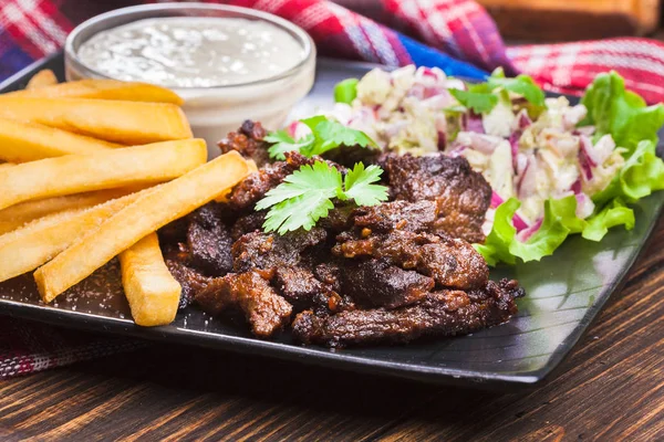 Kebab of beef with french fries and salad — Stock Photo, Image