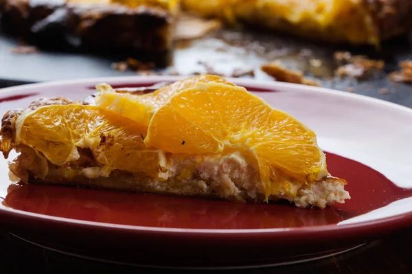Slice of tart with cheese and sliced orange — Stock Photo, Image
