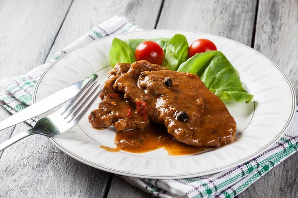 Pork chop with sauce and vegetables — Stock Photo, Image