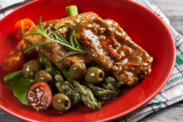 Pork chop with sauce and asparagus — Stock Photo, Image