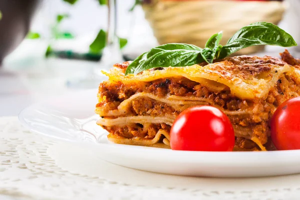 Piece of tasty hot lasagna with red win — Stock Photo, Image