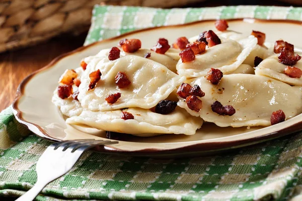 Dumplings with meat or cabbage and mushroom or cheese seasoned fried bacon — Stock Photo, Image