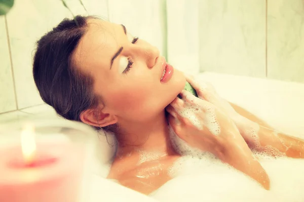 Young beautiful naked red-haired woman takes bubble bath — Stock Photo, Image