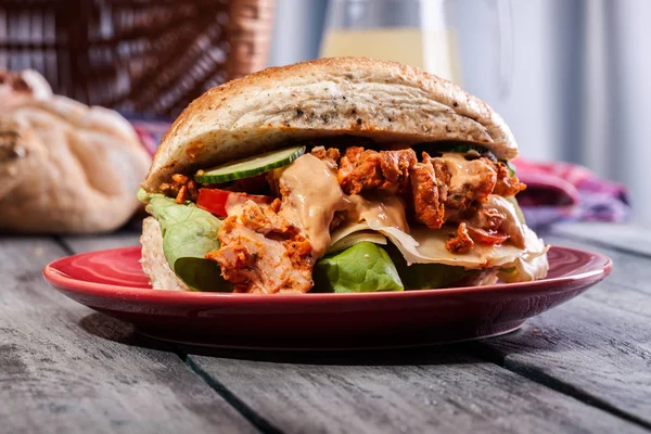 Gebratenes Hühnerfleisch mit Käse und Gemüse im Brötchen — Stockfoto