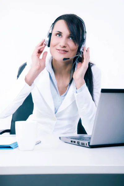Female call center service operator at work. Attractive female helpdesk employee with headset at workplace — Stock Photo, Image