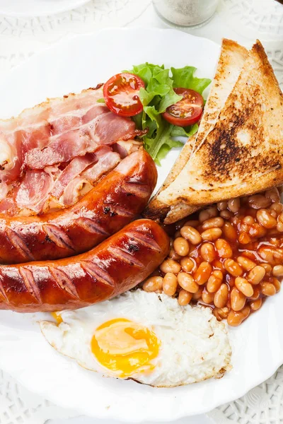 Engelsk frukost med bacon, korv, stekt ägg och vita bönor — Stockfoto