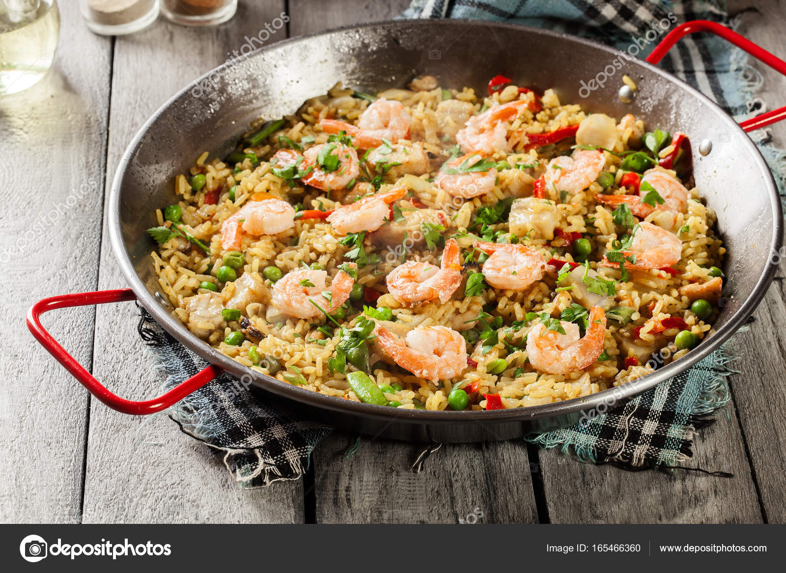 Traditional seafood paella with shrimp, fish and chicken seved in