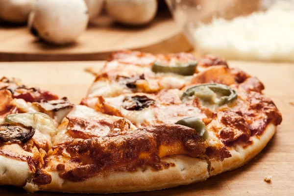 Slices of pizza with bacon, olives and jalapeno papper — Stock Photo, Image