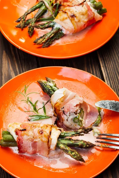 Baked fresh asparagus wrapped in chicken and bacon — Stock Photo, Image