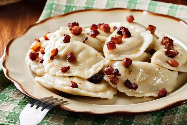 Dumplings with meat or cabbage and mushroom or cheese seasoned fried bacon — Stock Photo, Image