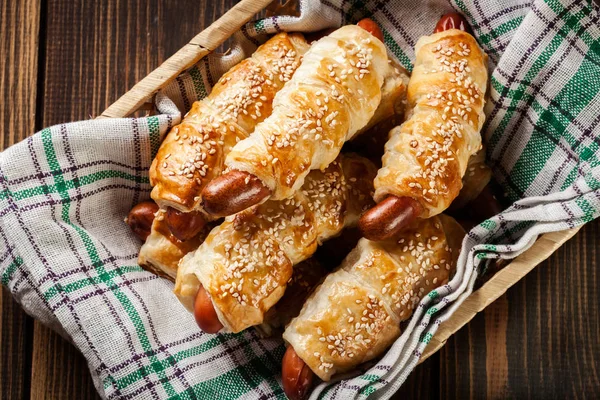 Rolled hot dog sausages baked in puff pastry — Stock Photo, Image