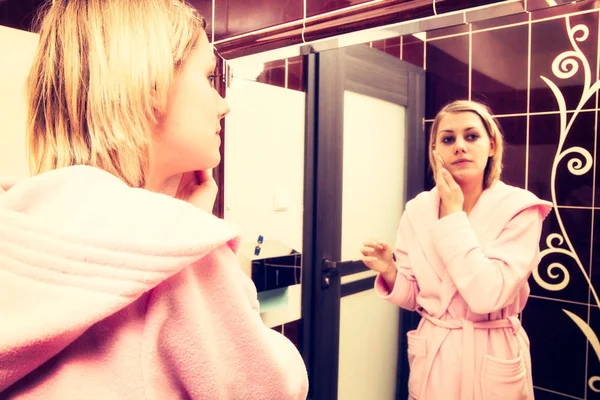 Blonde woman cleanse her face before make-up. Girl wearing in dressing-gown — Stock Photo, Image