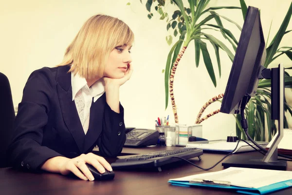 Блондинка-бизнесвумен работает за компьютером в офисе — стоковое фото