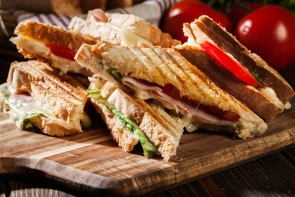 Stack of panini with ham, cheese and lettuce sandwich — Stock Photo, Image