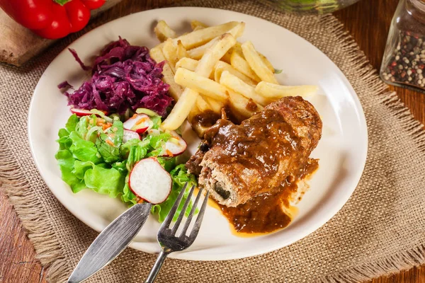 Pork roulade with french fries with salad — Stock Photo, Image