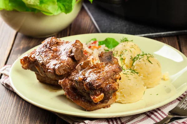Pork spare ribs served with mashed potatoes and sauce — Stock Photo, Image
